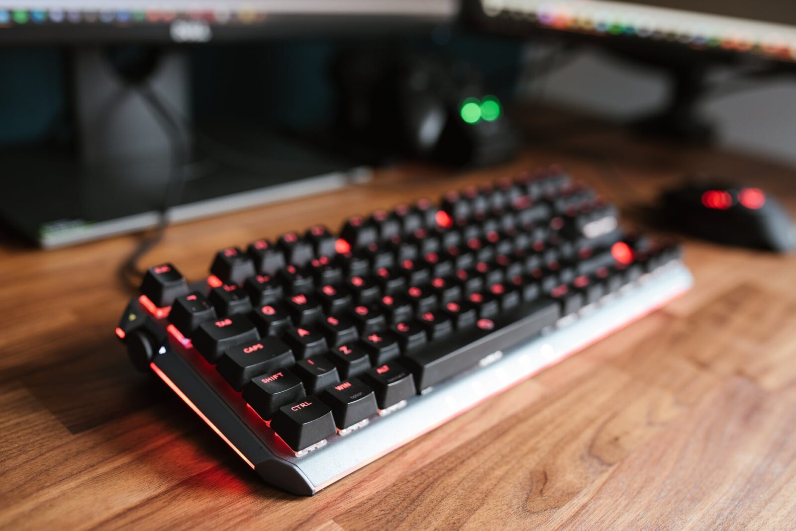 modern keyboard on wooden desk near mouse